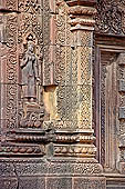 Banteay Srei temple - sculpted devata represented in a shrine, geese decorate the shrine 
